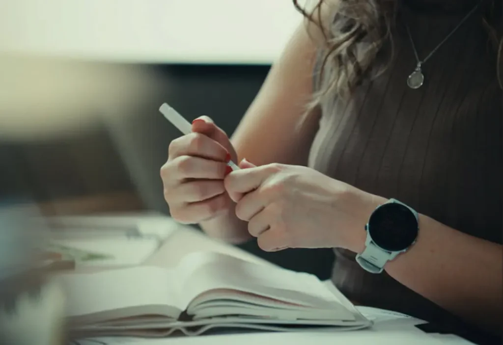 Kailey writes at her workspace.